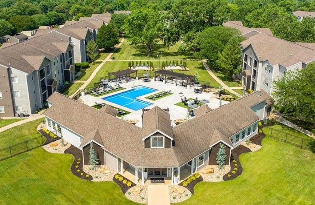 Aerial photo of condo association with pool in center